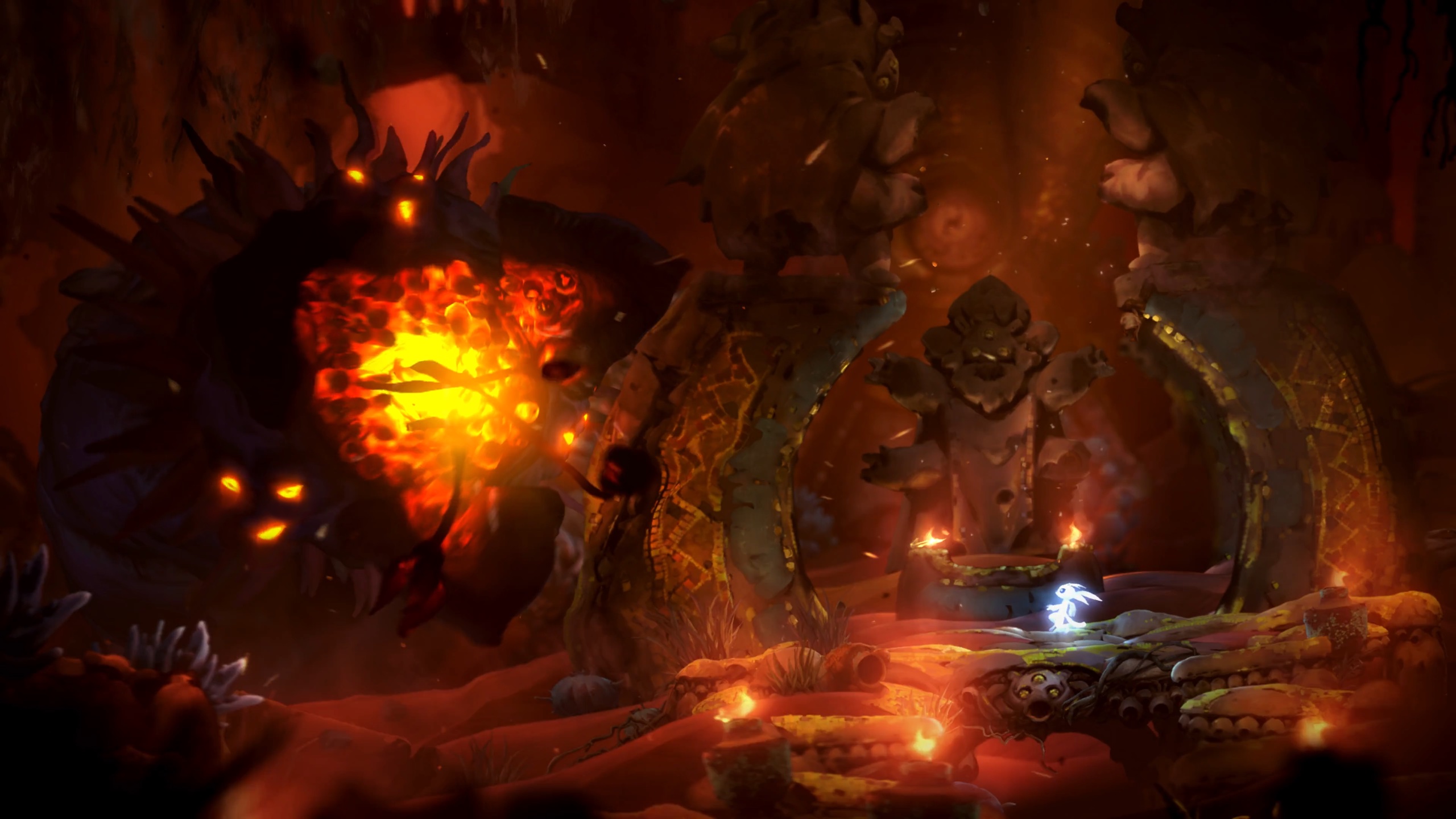 Ori facing a blazing combat shrine enemy inside a torch-lit arena